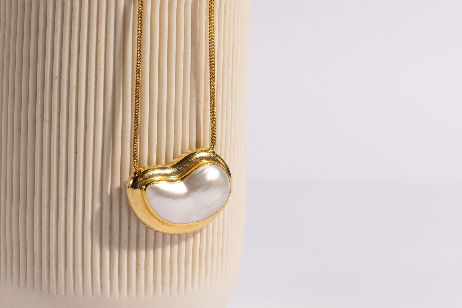 A diamond necklace presented on a display bust in a private appointment
