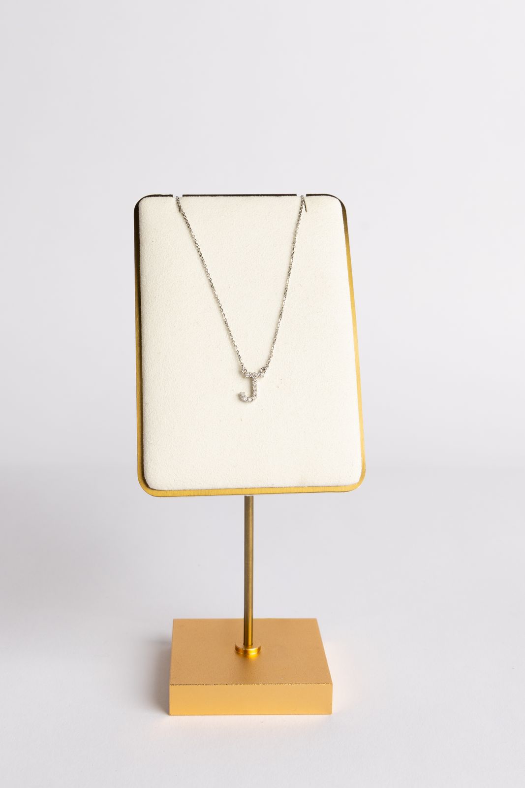 A necklace presented on a stand in a private appointment setting